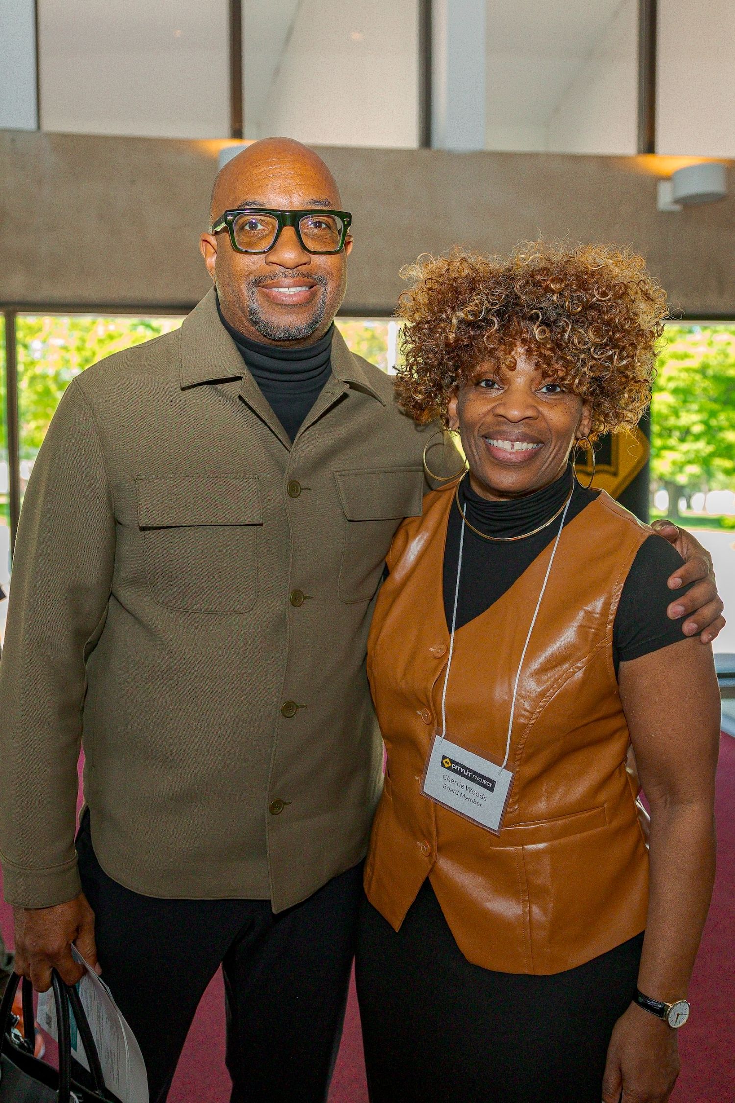 An attendee and board member Cherrie Woods pose for a photo